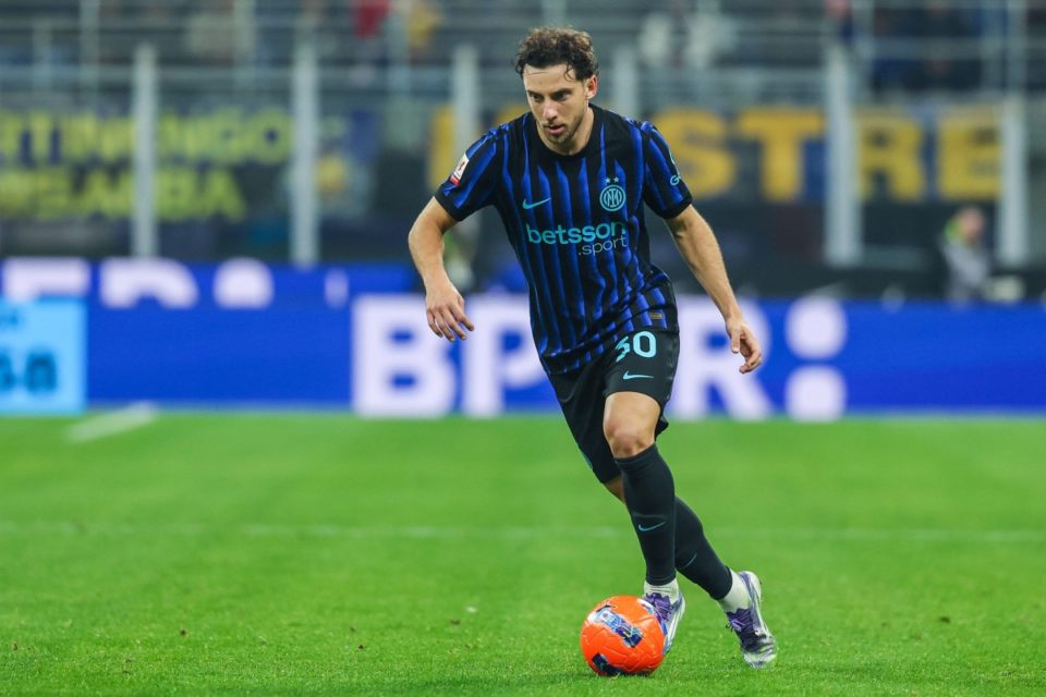 Carlos Augusto in Inter's blue and black home kit in action